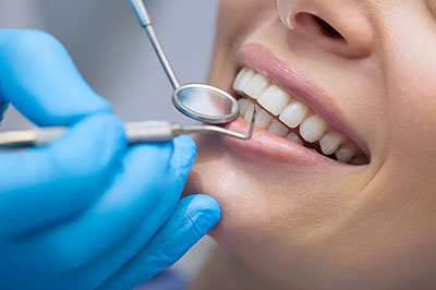 A woman receiving dental care with a smiling expression.